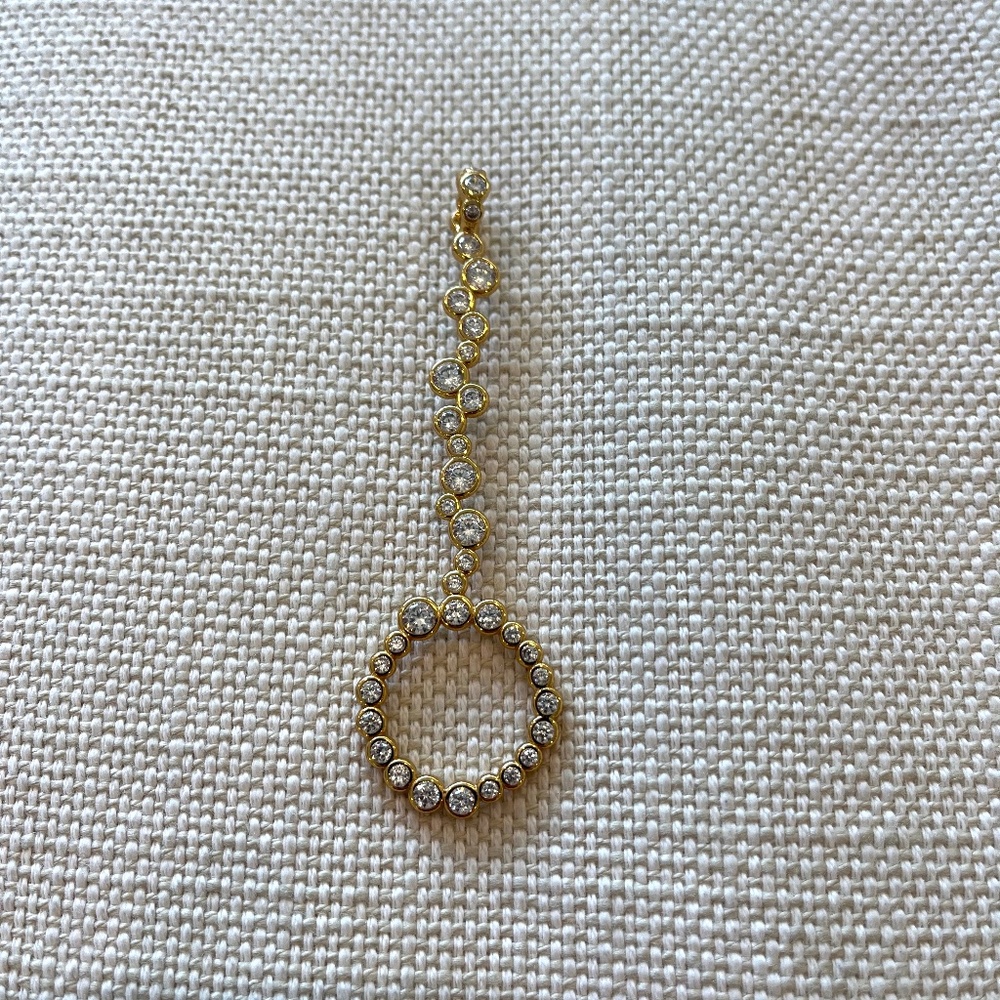 Gold plated cigarette holder (or joint holder) ring with clear stones.